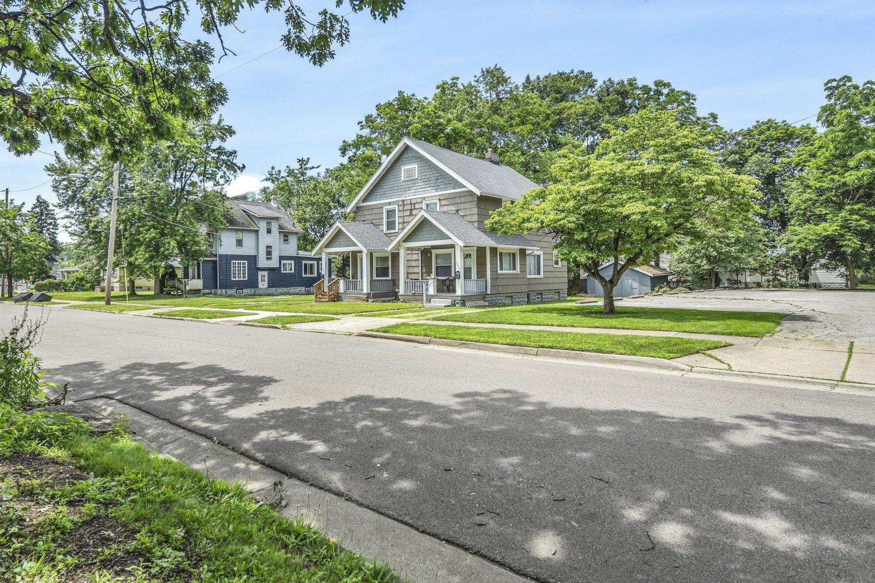 Sunlit residential street with single-family homes