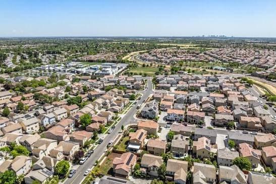 Aerial view of a Natomas neighborhood with downtown Sacramento on the horizon