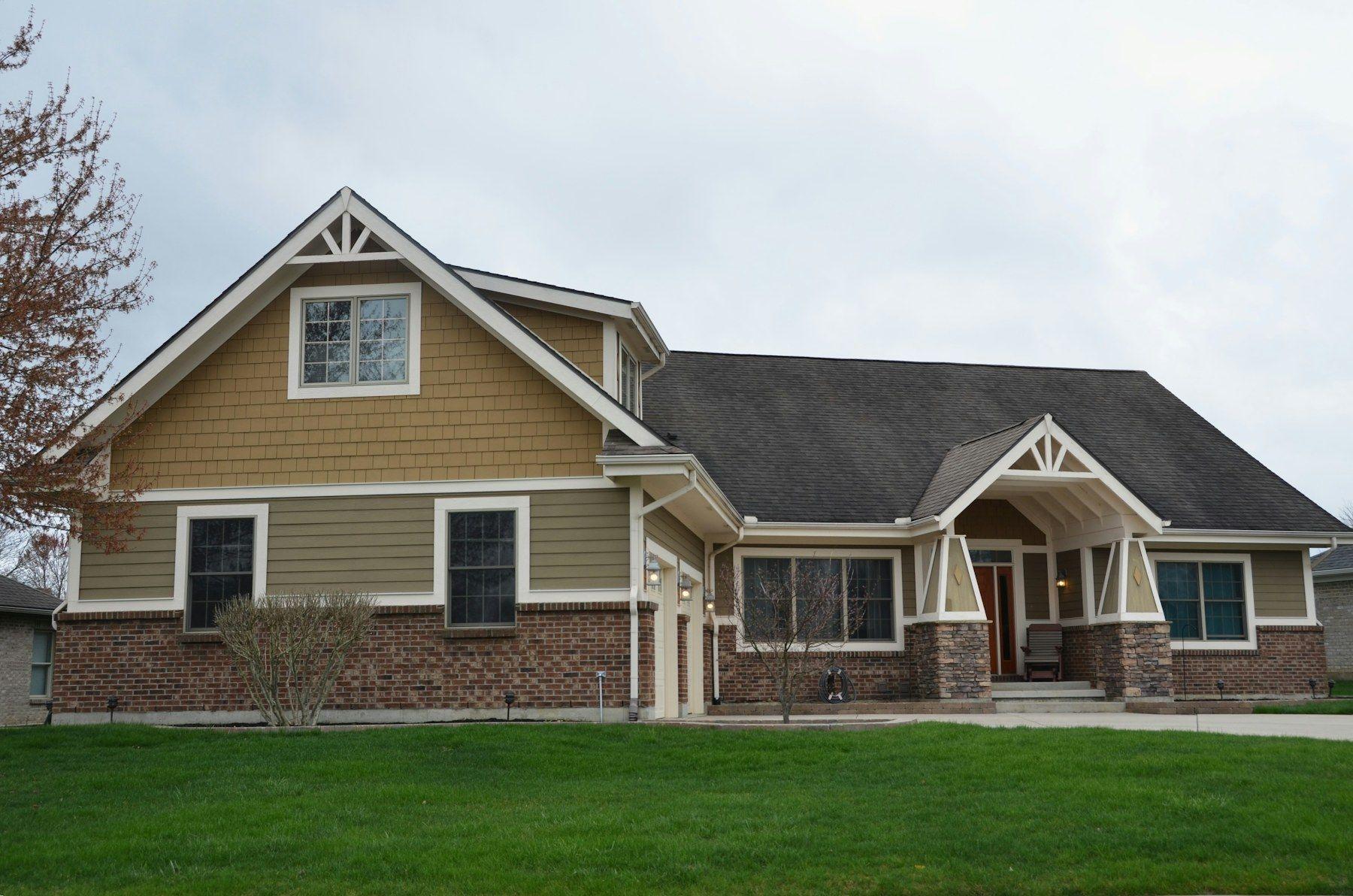 Newer craftsman-style single-story home with a wide lawn
